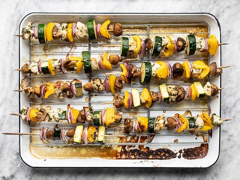 Broiled kebabs on the baking sheet.