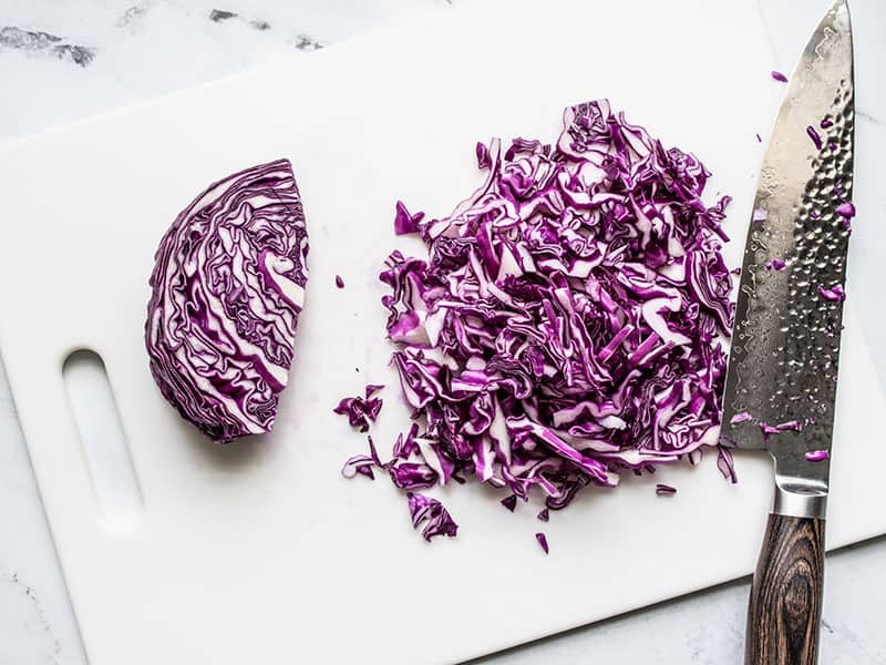 Shredded red cabbage on a cutting board