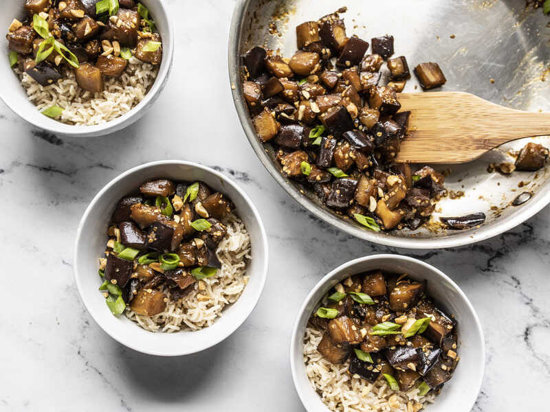 Soy Glazed Eggplant being served from the skillet into three bowls