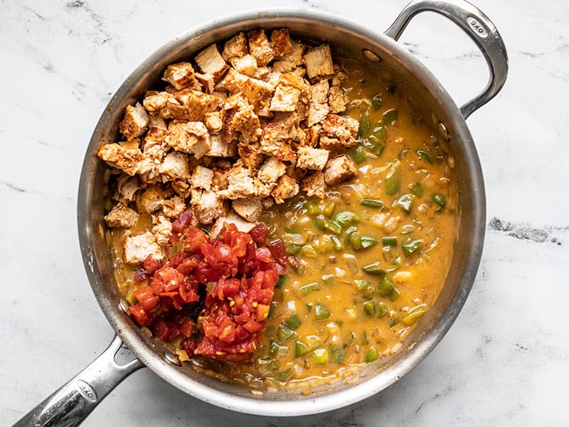 Diced chicken and drained tomatoes added to the skillet