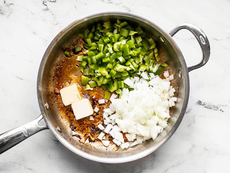 Onion bell pepper and butter in the skillet