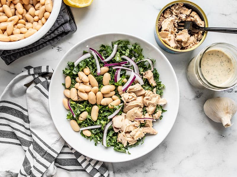 Building the salmon and kale salad with drained beans and canned salmon on the side.