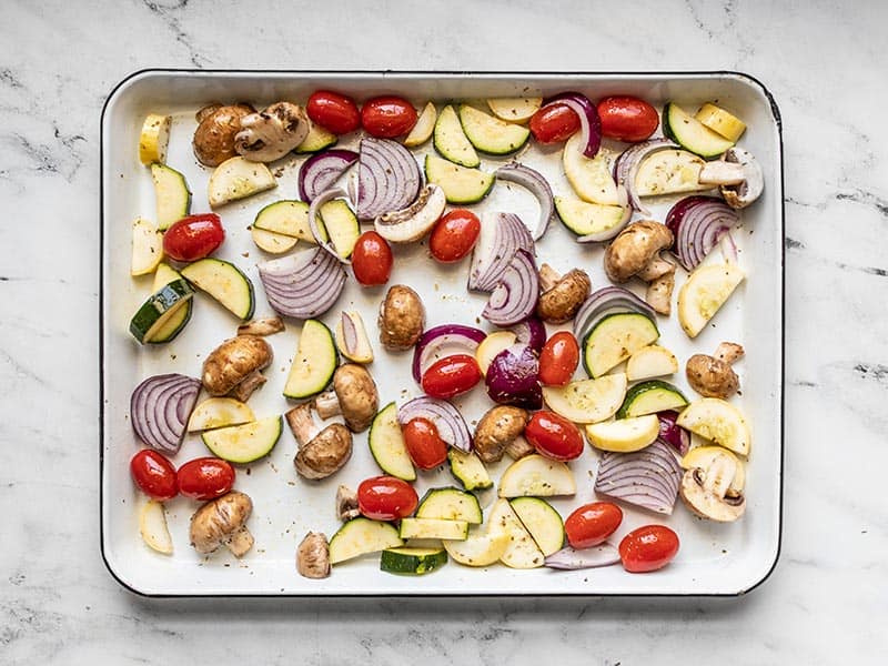 Chopped vegetables ready to roast on a sheet pan.