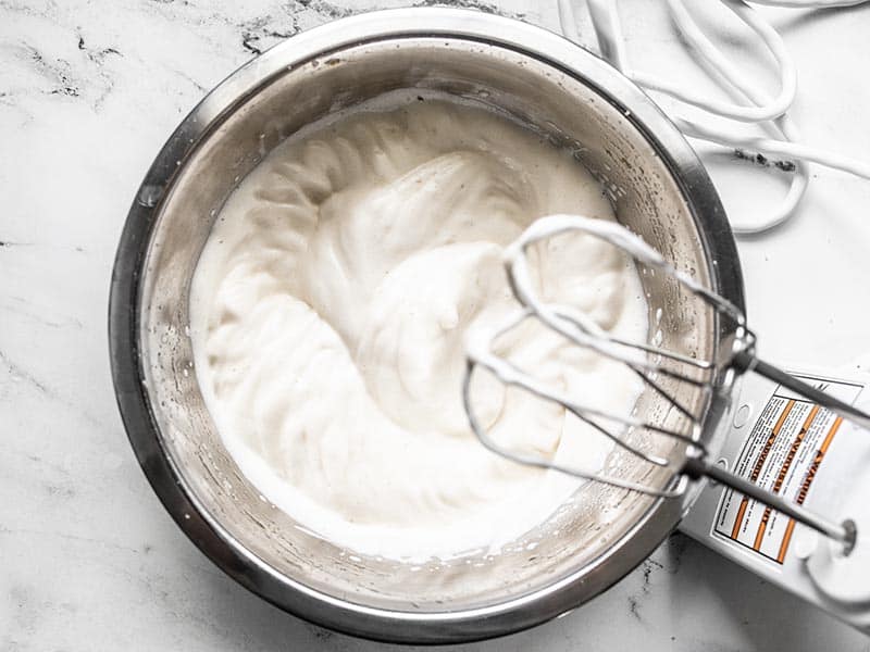 Sweetened whipped aquafaba in a metal bowl