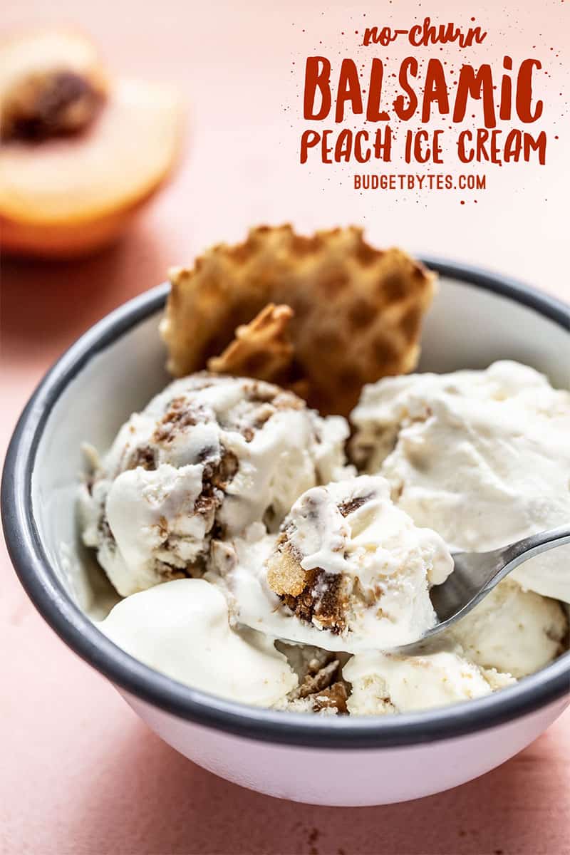 Side view of a bowl of no churn balsamic peach ice cream with a fresh peach in the back. title text at top.