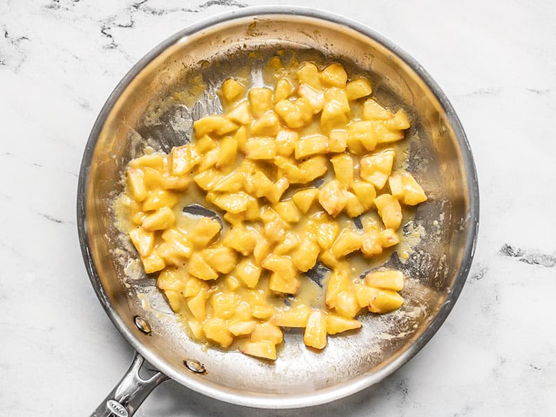 Peaches sautéed in butter in a skillet