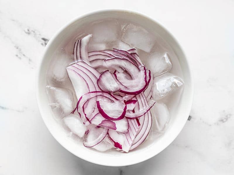 Sliced Red onion in ice water