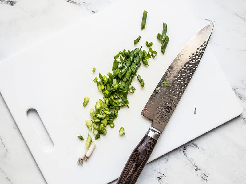 Sliced green onions on a cutting board