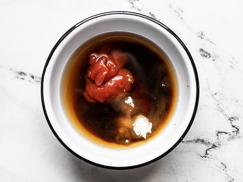 Sweet and sour sauce ingredients in a bowl, unmixed.