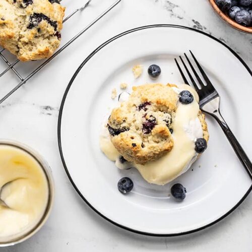 A Blueberry Lemon Curd Shortcake on a plate surrounded by the ingredients