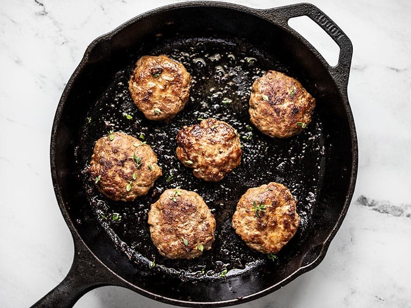 Cooked Maple Sage Breakfast Sausage in a cast iron skillet