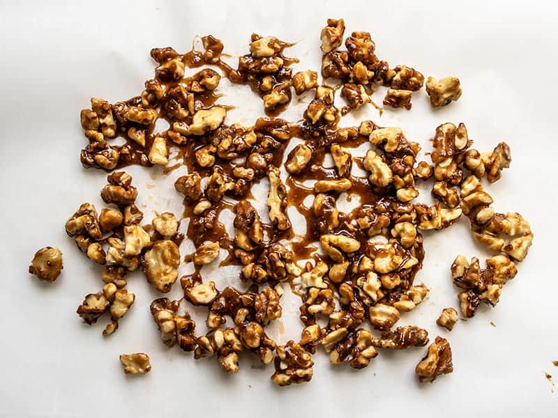 Candied walnuts cooling on parchment