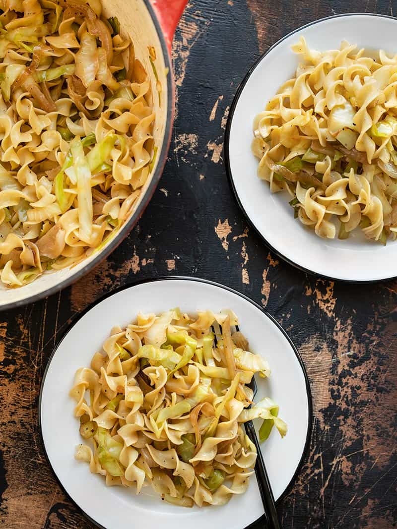 Fried Cabbage and Noodles in a large pot, served onto two white plates