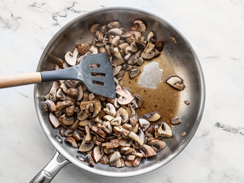 Water releasing from mushrooms in the skillet