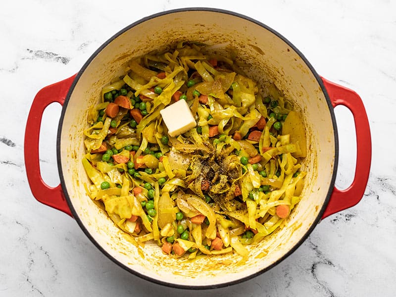 Season cabbage with butter salt and pepper