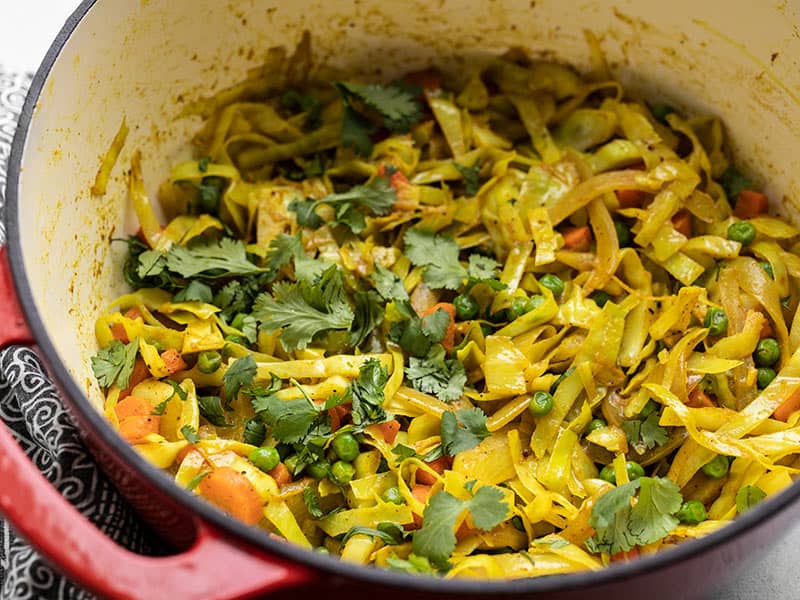 Close side view of the curried cabbage topped with cilantro in the pot.