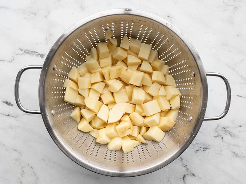 Cubed potatoes in a colander