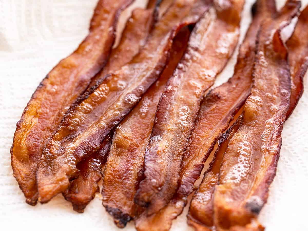 Close up of oven baked bacon on a paper towel.