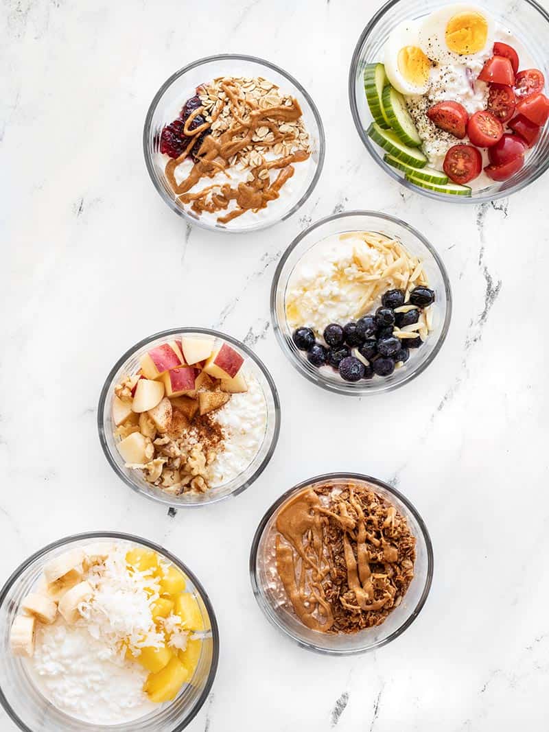 Six flavors of Cottage Cheese Breakfast Bowls in glass meal prep containers