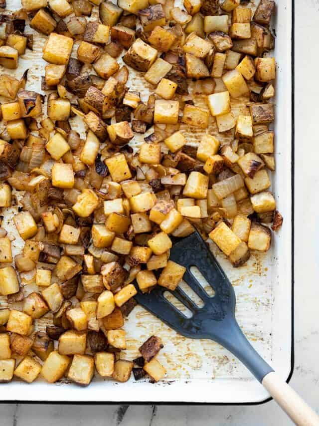 A sheet pan full of roasted breakfast potatoes with onions