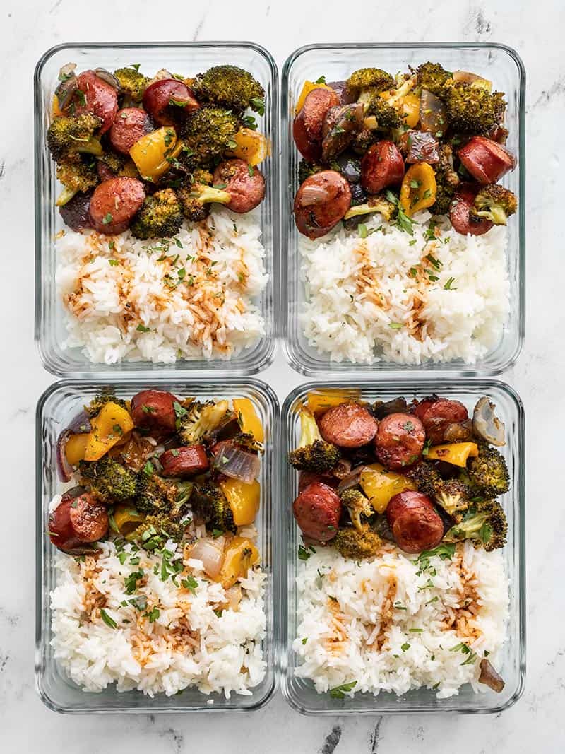 meal prepped roasted sausage and vegetables in rectangular glass containers