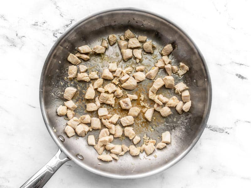 Cooked chicken in the skillet with garlic and ginger