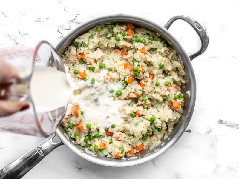 Heavy cream being added to the skillet