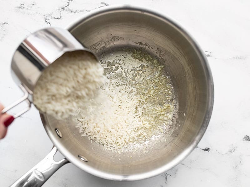 Rice being poured into the pot