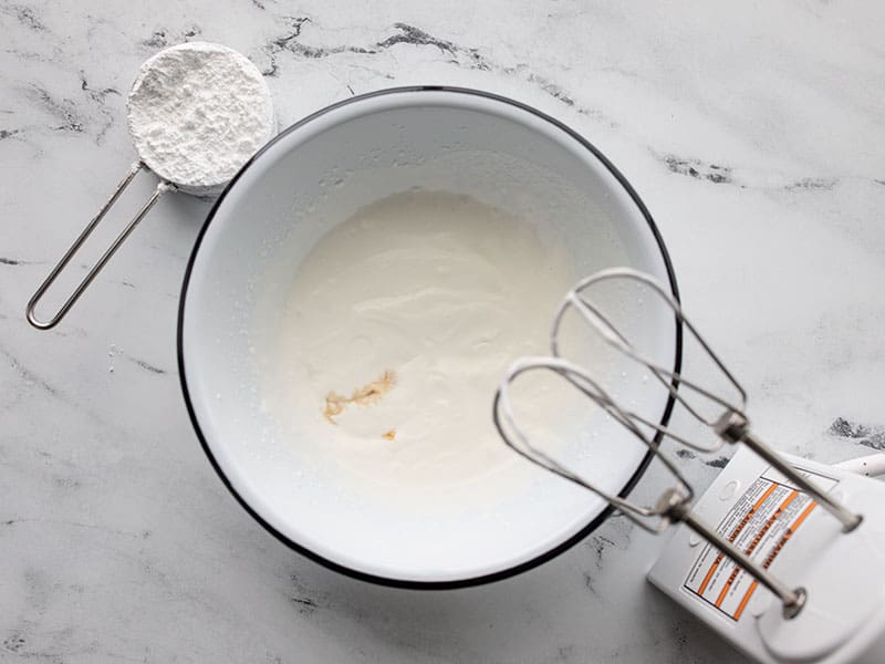 Half whipped heavy cream with vanilla and powdered sugar