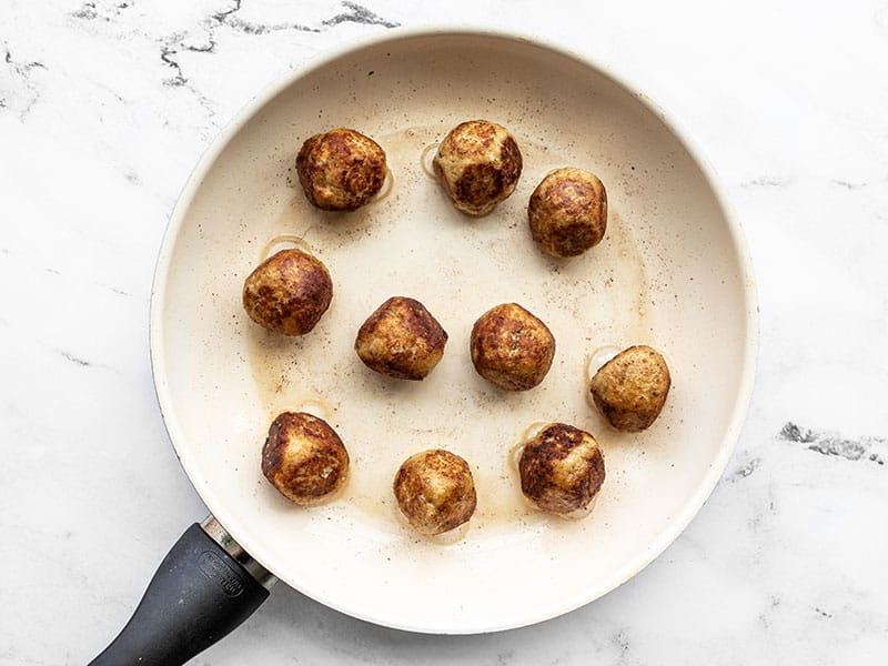 Cooked meatballs in a skillet