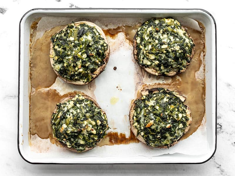 Baked spinach stuffed portobello caps, still on baking sheet