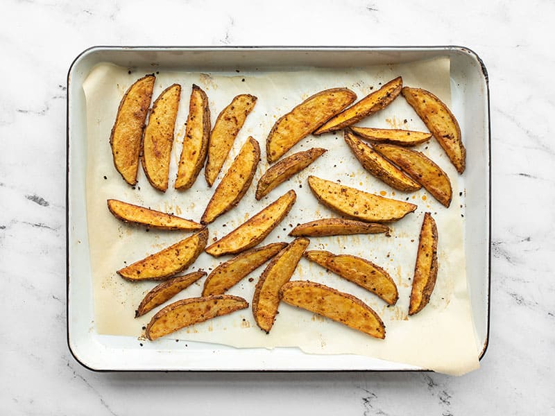 Baked steak fries on the baking sheet