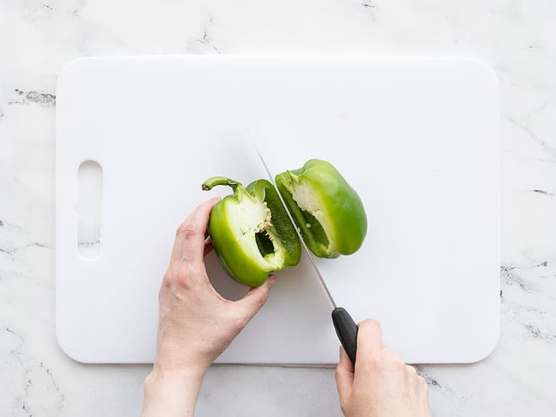 Bell pepper being sliced in half