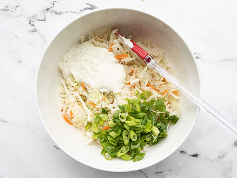 Ranch slaw ingredients in a mixing bowl