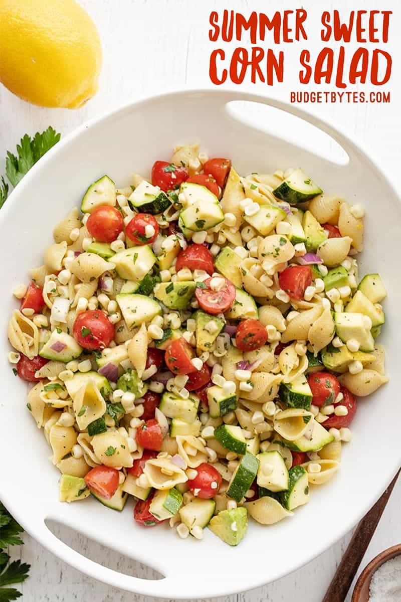 Overhead view of summer sweet corn salad in a bowl, title text at the top