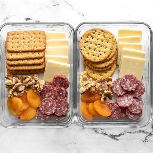 Four cheese board lunch boxes lined up in a row