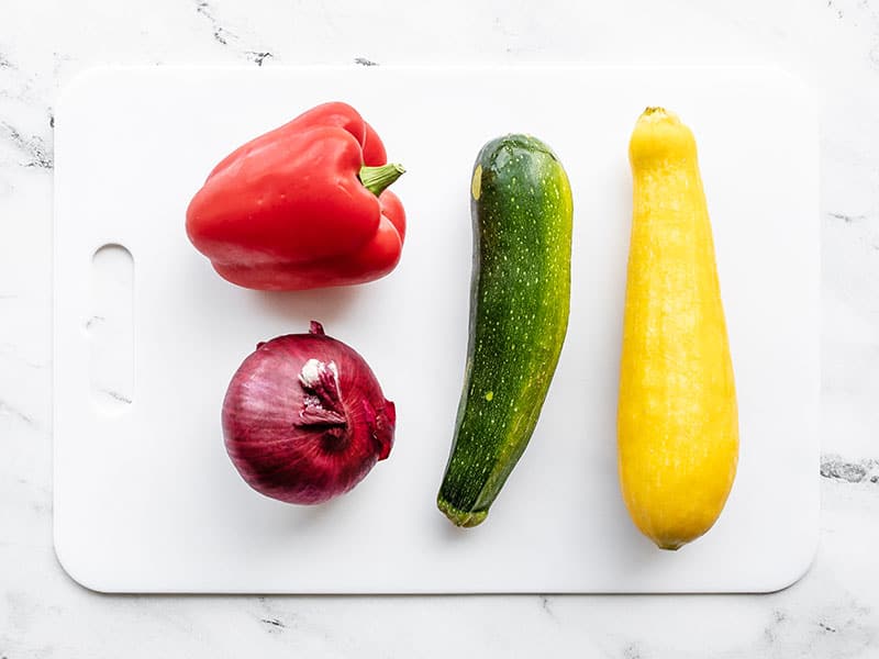 Whole vegetables on a cutting board