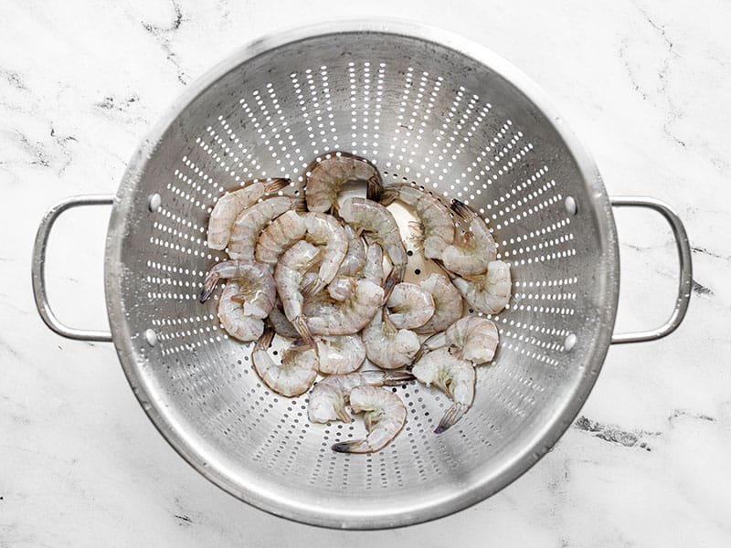 Thawed shrimp in a colander