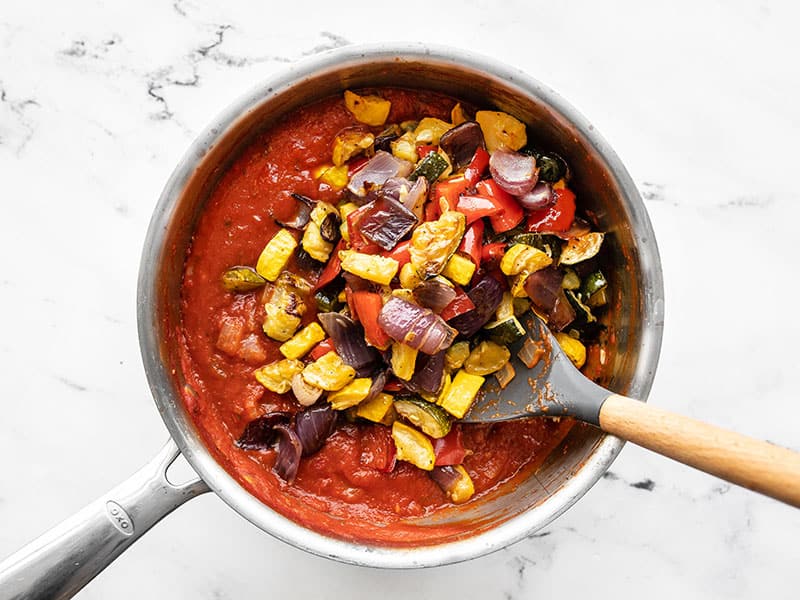 Roasted vegetables added to the pot of red sauce.