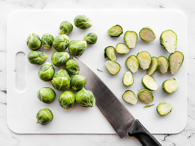 Brussels sprouts being cut in half