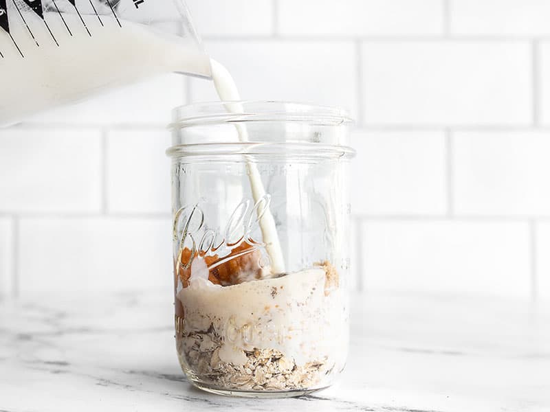 milk being poured into the jar