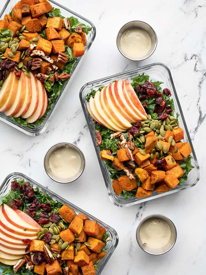 Autumn kale and sweet potato salads in glass meal prep containers