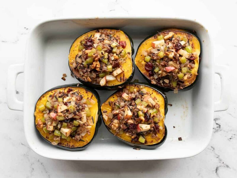 Stuffed and baked acorn squash in a casserole dish