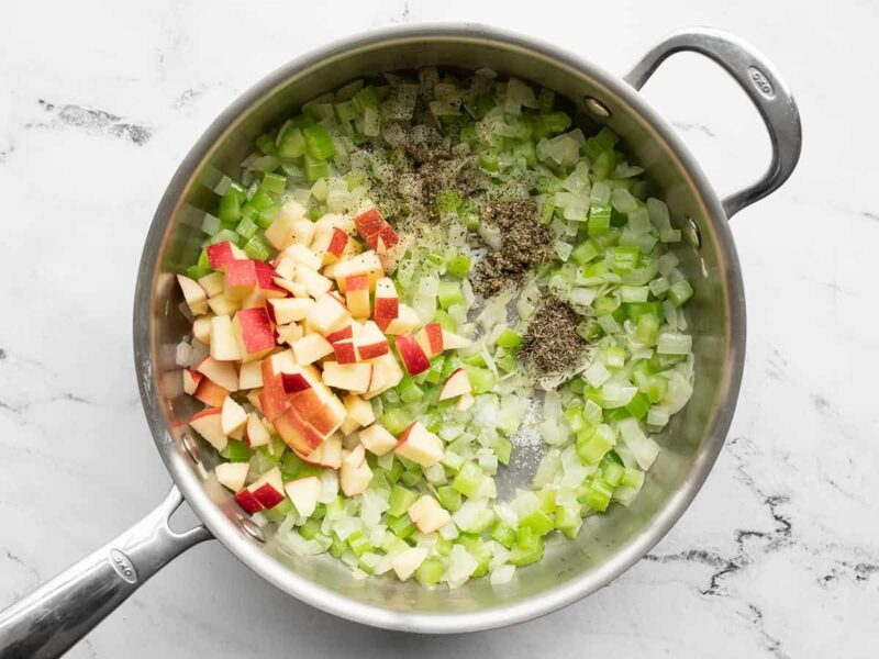 Apple and herbs added to the skillet