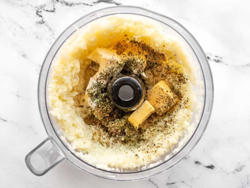 Seasoning added to food processor with the cauliflower