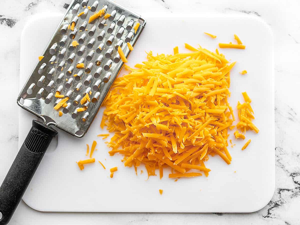 Shredded cheddar on a cutting board