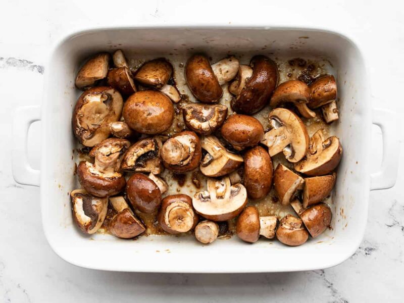 Seasoned mushrooms in the dish before roasting