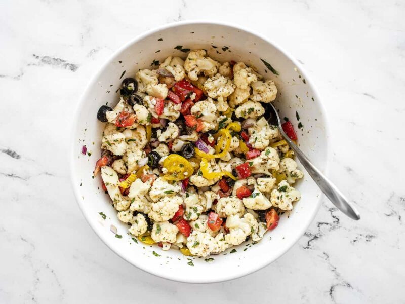 Finished marinated cauliflower salad in the bowl with a spoon