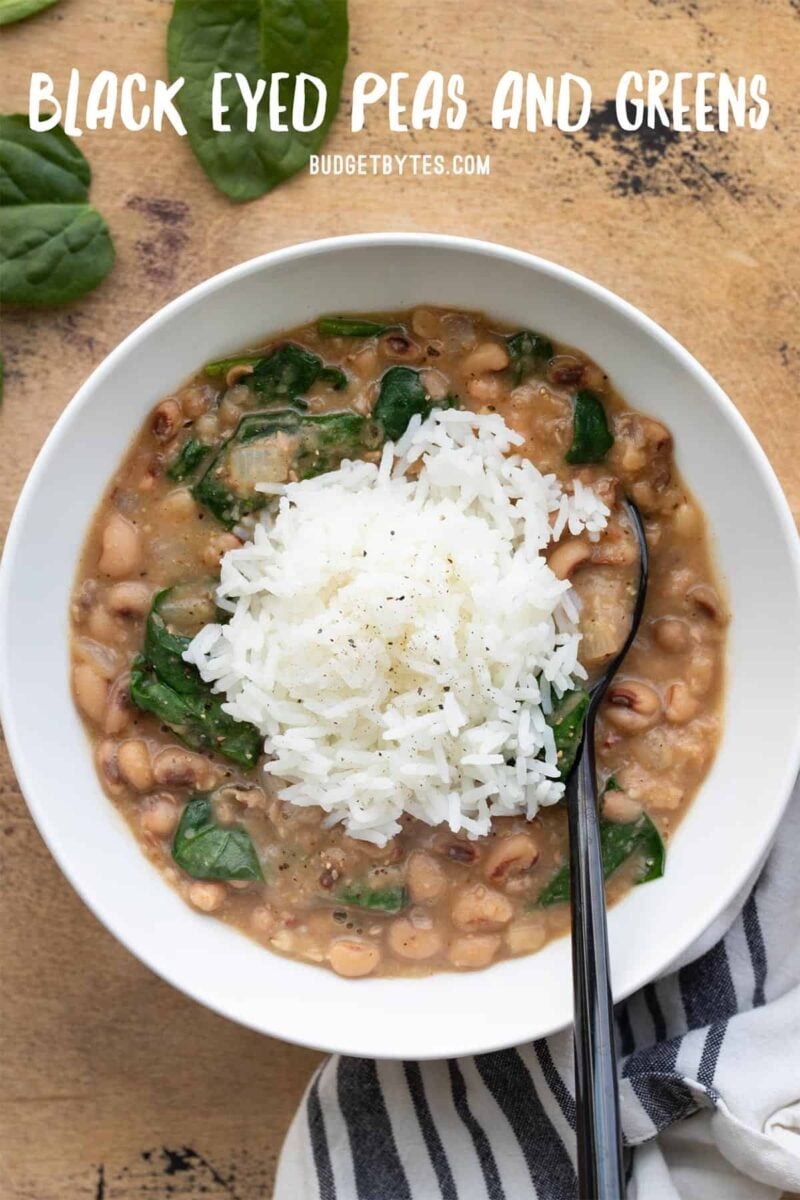 Overhead view of a bowl full of black eyed peas and greens with rice, title text at the top