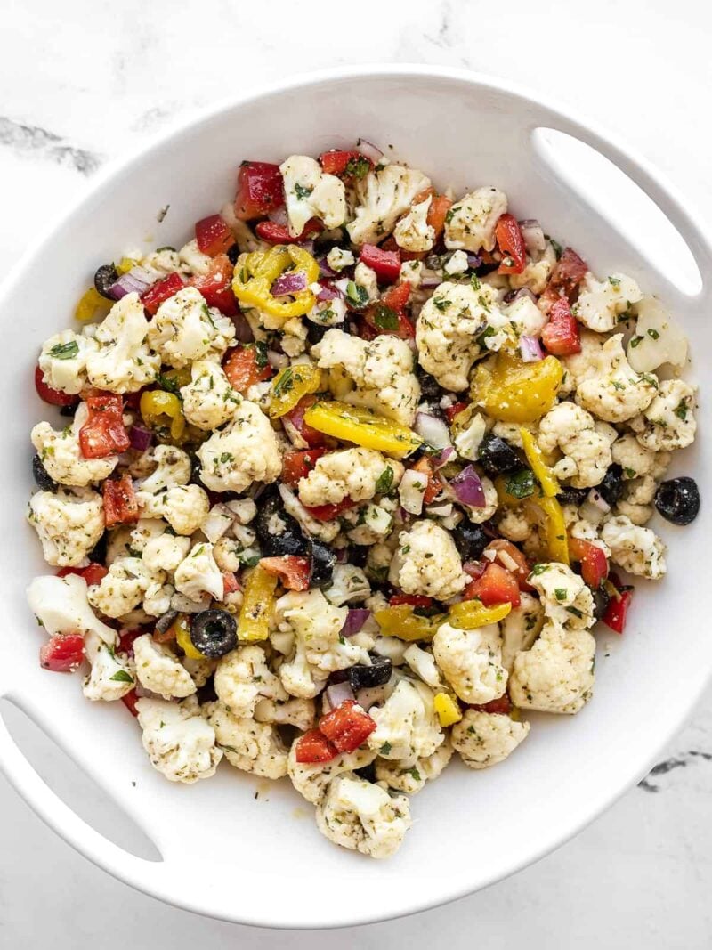 Overhead view of marinated cauliflower salad in a serving bowl